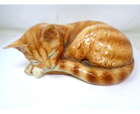 A Goebel figure of a sleeping cat (height 9cm).