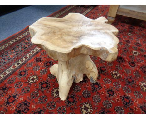 A rustic hardwood tree trunk stool.