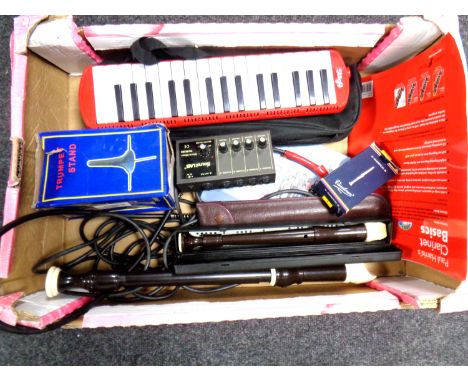 A box containing musical items including Stagg Melodion with case, recorders, trumpet stand, clarinet reeds, a Sound Lab WAM2