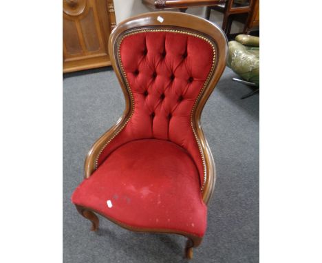 A Victorian style lady's chair upholstered in red button dralon.