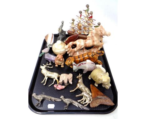 A tray containing polished stone, ceramic and metal animal figures.