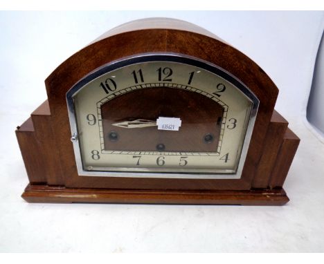 An Art Deco walnut cased mantel clock.