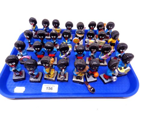 A tray containing a quantity of ceramic Robertson's Golly band figures.