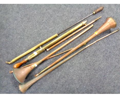 A box containing a quantity of vintage copper hunting horns together with two further vintage brass rose sprayers.