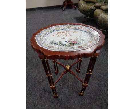A Japanese style occasional table with scalloped lift off tray (diameter 48cm) with an inset ceramic plate.