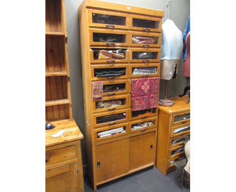 Two similar banks of light oak Haberdashers shop display drawers with sliding cupboard doors to the base, 214 x 92cm x 31 and