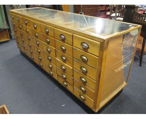 A light oak Haberdashers shop display counter with 42 tiered slides, 91 x 213cm  