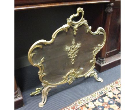 A firescreen and a pair of brass fire irons  