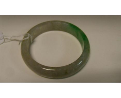 A Chinese green jadeite bangle, the outer diameter 7.5cm (3 in)  Good