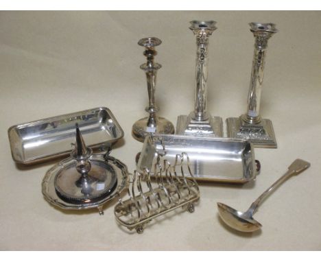 A pair of Adams style electroplate candlesticks, another circular base candlestick, a chamber stick, a rectagular electroplat