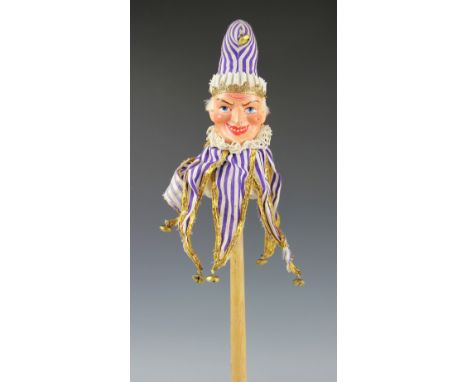 A papier mache stick puppet of Punch, late 19th/early 20th century, the puppet polychrome decorated and with a ruffle and bel