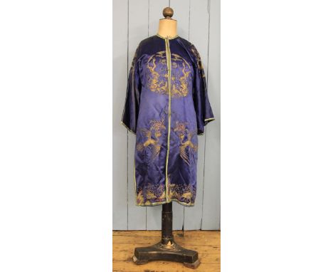 A Chinese silk embroidered robe, in blue silk with dragon, crane and thunder scroll detail in gilt thread, along with a pair 