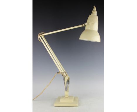 A Herbert Terry anglepoise desk lamp in cream, raised on stepped square base, 96cm high 
These are sold as decorative items o