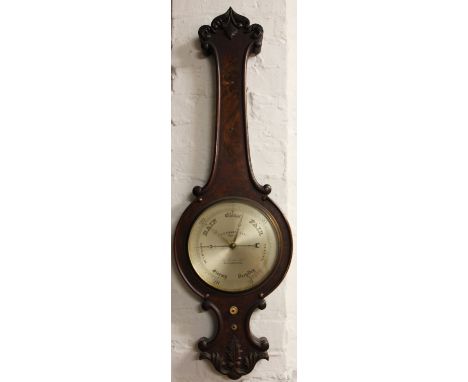 A Victorian stained walnut wheel barometer, the silvered dial printed J. Casartelli, carved decoration (lacking thermometer),