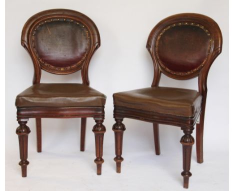 A set of four Victorian walnut dining chairs, with leather backs and seats, on turned legs (at fault), along with two William