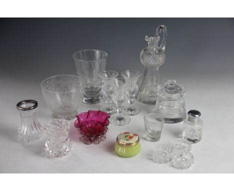 An assortment of glass wares, to include; a cranberry glass shell moulded bowl, a castle top honey pot with floral vine decor