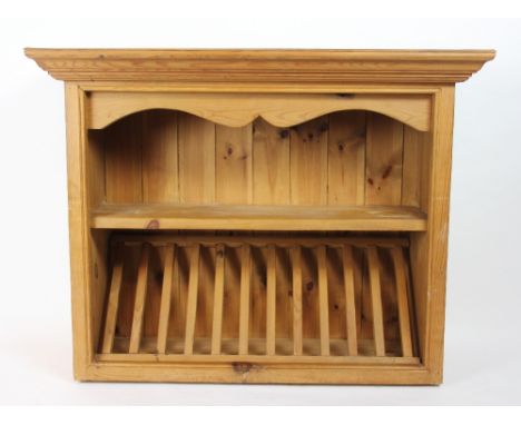 A pine hanging plate rack, with a ten division rack below a single shelf, with moulded cornice, 71cm H x 92cm W 