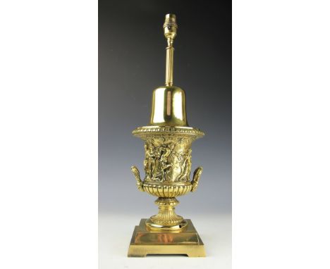 A lacquered brass table lamp, in the form of a twin handled urn and cast with figures, 53cmThese are sold as decorative items