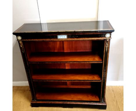 Walnut and ebonised low bookcase with ormolu mounts and relief moulded ceramic panels, some slight loses to the finish on the