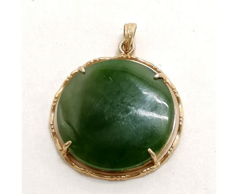 Circular jade pendant in a metal mount - 2.5cm diameter 
