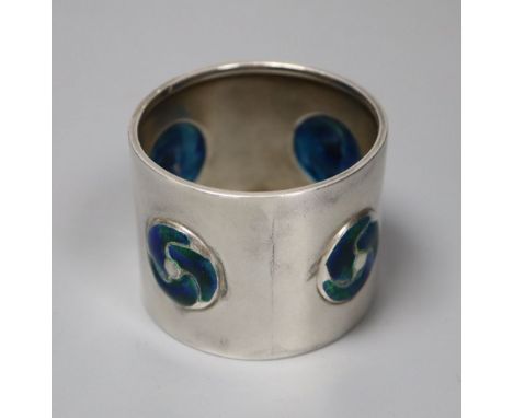 An Edwardian Art Nouveau silver and enamel napkin ring, William Hair Haseler, Birmingham, 1904, 38mm, gross 40 grams.