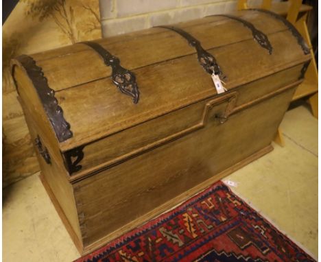 A 19th century pine dome top iron-bound travelling trunk/blanket chest on bun beet, width 128cm, depth 61cm, height 77cm