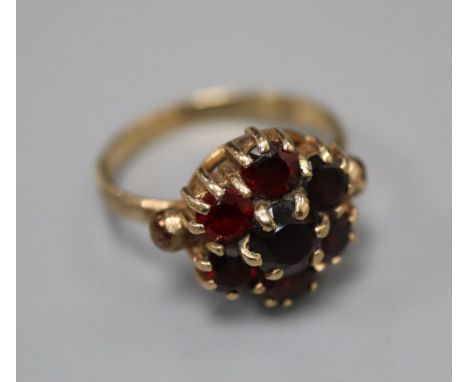 A 1960's 9ct gold and garnet cluster ring, size K/L, gross 3.2 grams.