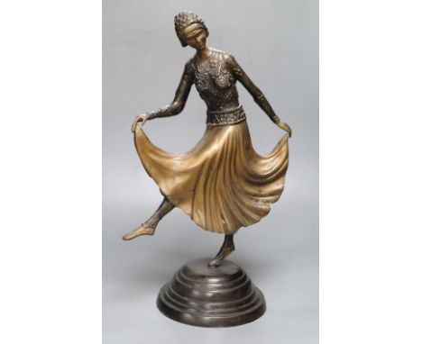 A patinated metal model of a 1930's dancer, on stepped circular base, 48cm