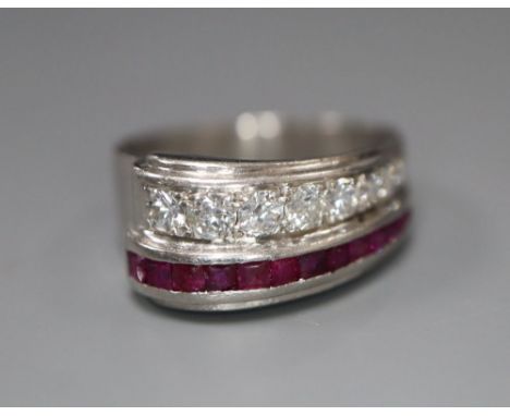 A stylish white metal (stamped Plat), graduated ruby and diamond set twin row dress ring, size O, gross 7.2 grams.CONDITION: 