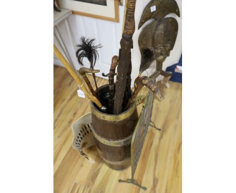 A brass bound coopered oak stickstand, assorted sticks a firescreen etc