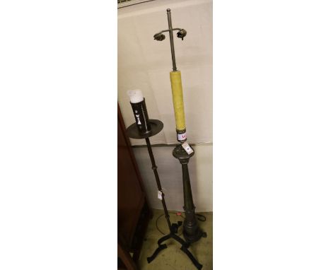 A wrought iron church style candlestand and a metal standard lamp and shade
