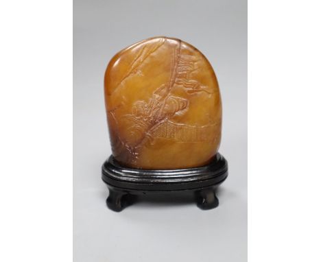 A Chinese amber coloured soapstone seal, late 19th / early 20th century, wood stand, overall height 10.5cm