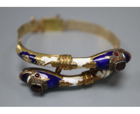 A Victorian pierced yellow metal, two colour enamel and garnet set twin serpent head hinged bracelet, gross 22.5 grams (a.f.)