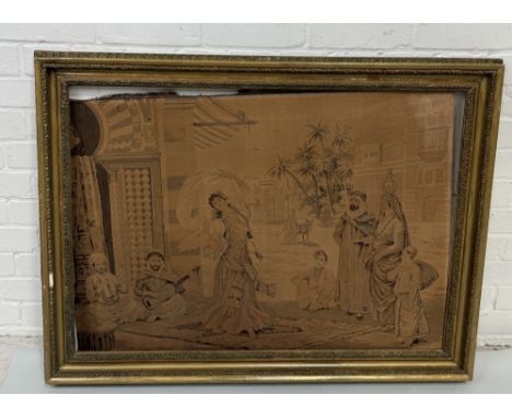 A EMBROIDERY DEPICTING AN ARABIC DANCER IN THE STREETWith gilt wood frame 100cm x 76cm