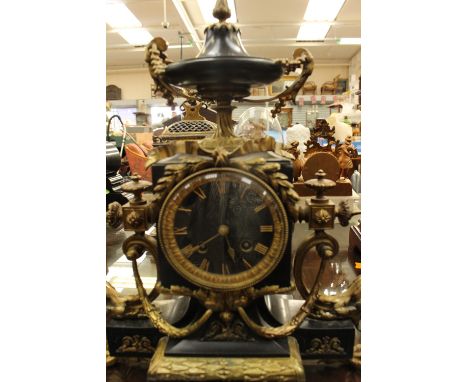 A French 19th Century Empire style slate and gilt metal clock with claw feet 