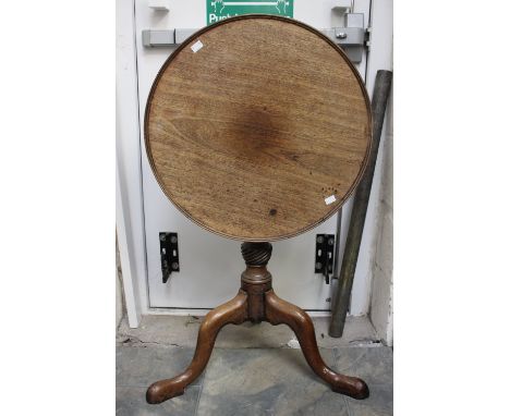 A George III mahogany tilt-top tripod table, the circular dished top raised on a turned column and standing on three cabriole