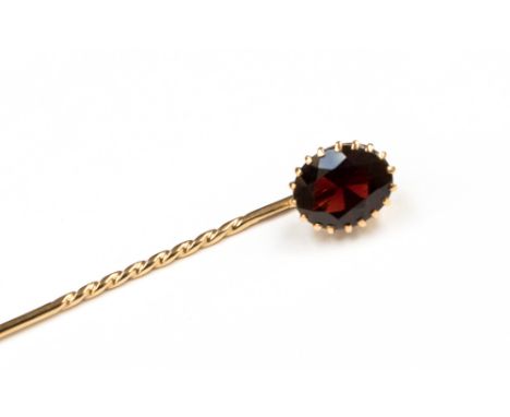 A garnet and 9ct yellow gold stick pin, the claw set faceted oval garnet approximately 10 x 8mm