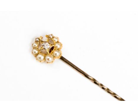 A Victorian diamond and seed pearl yellow metal crescent and star stick pin, the eight cut diamond set star within the gradua