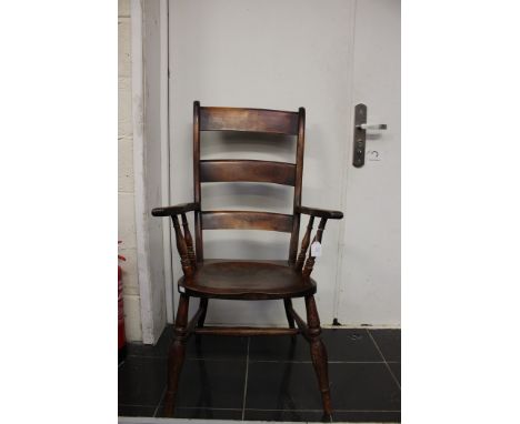 A 19th Century ladder back open armchair, of regional design, saddle seat and standing on turned legs