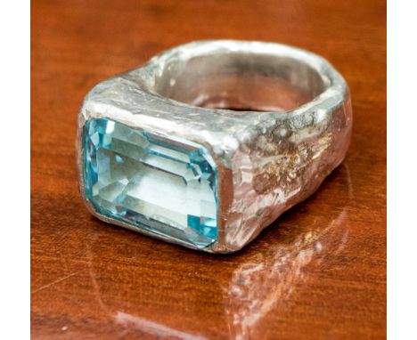 A large rectangular topaz set in a chunky silver ring, gross weight 38.3 grams approx, size S 