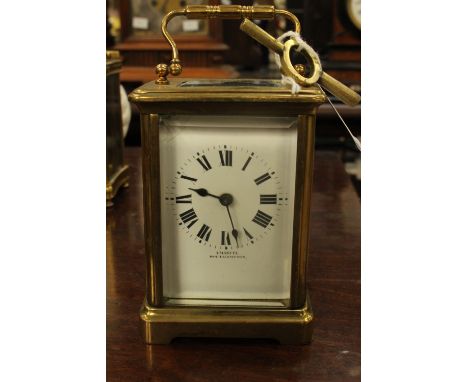 A French circa 1910/20 carriage clock, brass, glass panels, enamel dial with Roman numerals, retailed by Emmanuel's Southampt