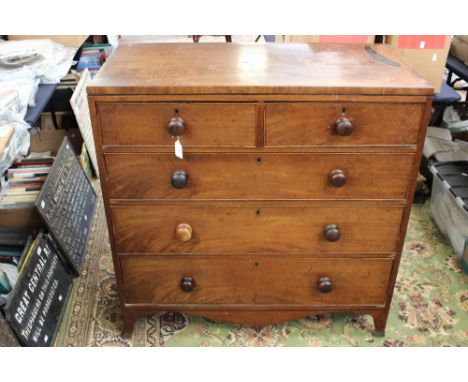 An early Victorian mahogany chest of drawers, comprising two short over three long graduated drawers, all retaining turned ha