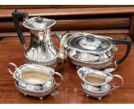 A George V silver four piece tea and coffee service, comprising teapot, coffee pot, milk and sugar bowl, each piece having a 