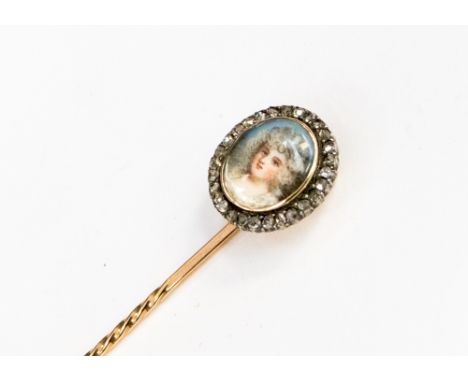 A mid Victorian portrait miniature yellow metal stick pin, circa 1860, depicting a young maiden in white gown and a sky blue 