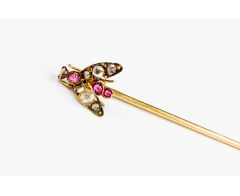 A Victorian novelty diamond, ruby and garnet stick pin designed as a fly, the body set with three graduating cabochon rubies 