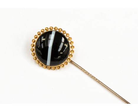 A Victorian banded agate yellow metal stick pin, the black and white striped agate cabochon approximately 18.78mm diameter wi