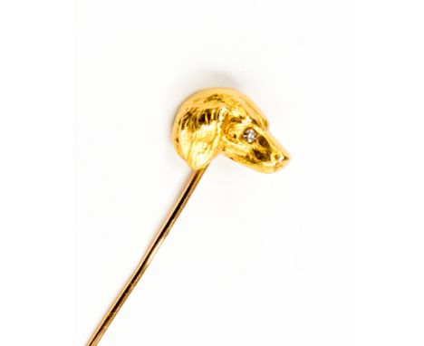 A Victorian novelty yellow metal stick pin in the form of a dogs head with eight cut diamond set eye, head approximately 15.0