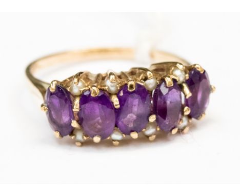 A 5 stone oval Amethyst ring with seed pearl details, claw set in 9ct gold size Q 1/2 with a total gross weight of 3gms