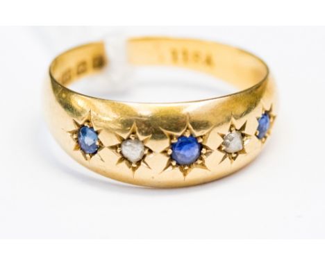 An Sapphire and diamond 5 stone star set ring in 18ct yellow gold 3gms, size N 