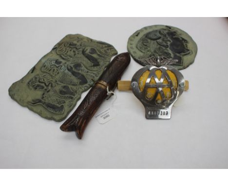 An Indian knife and fork in a carved fish holder, an AA Badge 1950s; together with two 1970's Greek plaques (4) 